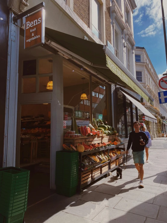 two people walking outside a store that sells different foods