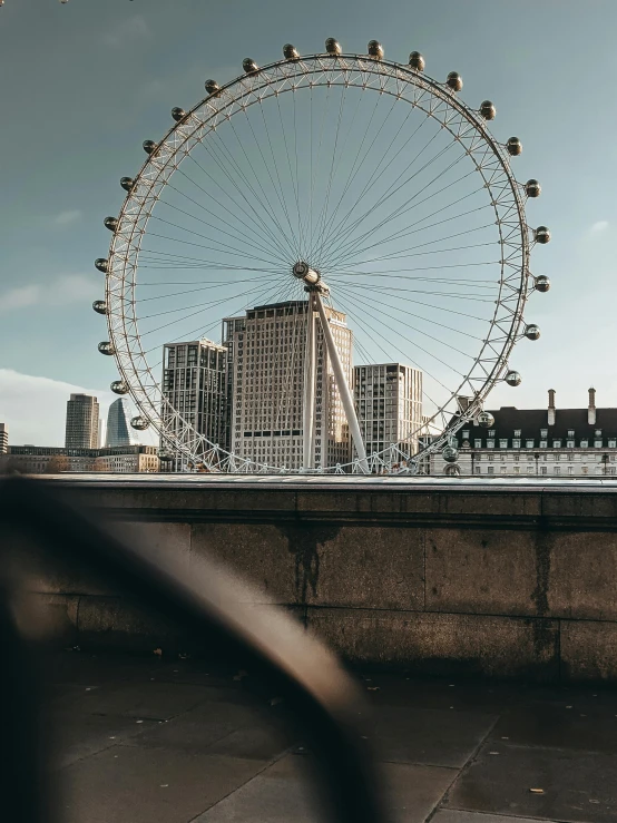 the ferris wheel is next to some buildings