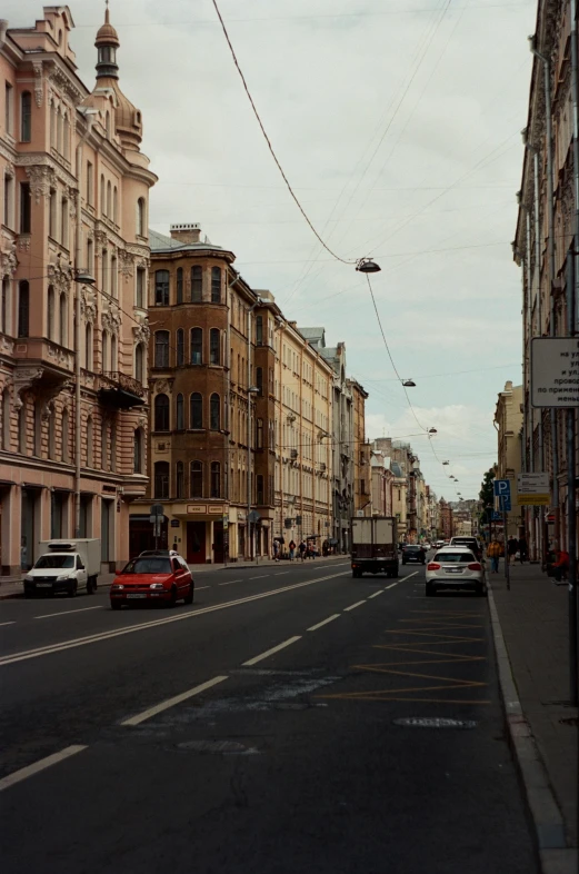 a city street with cars and buildings lining it