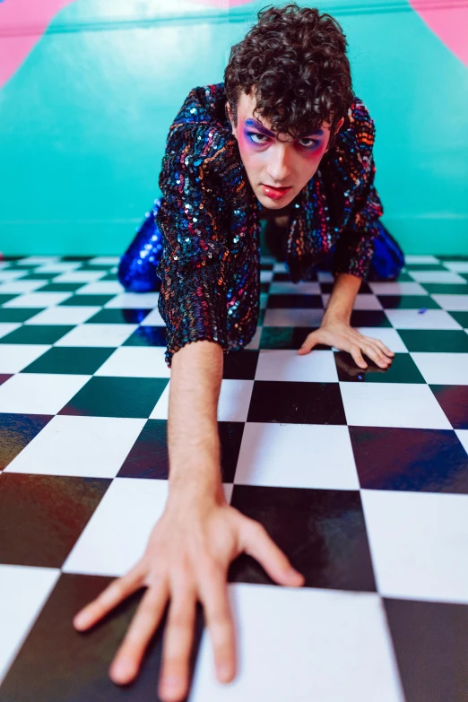 a young man who is wearing blue glitters