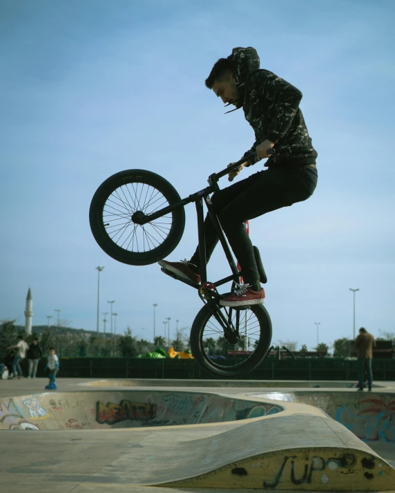 a man riding a bike down the side of a ramp