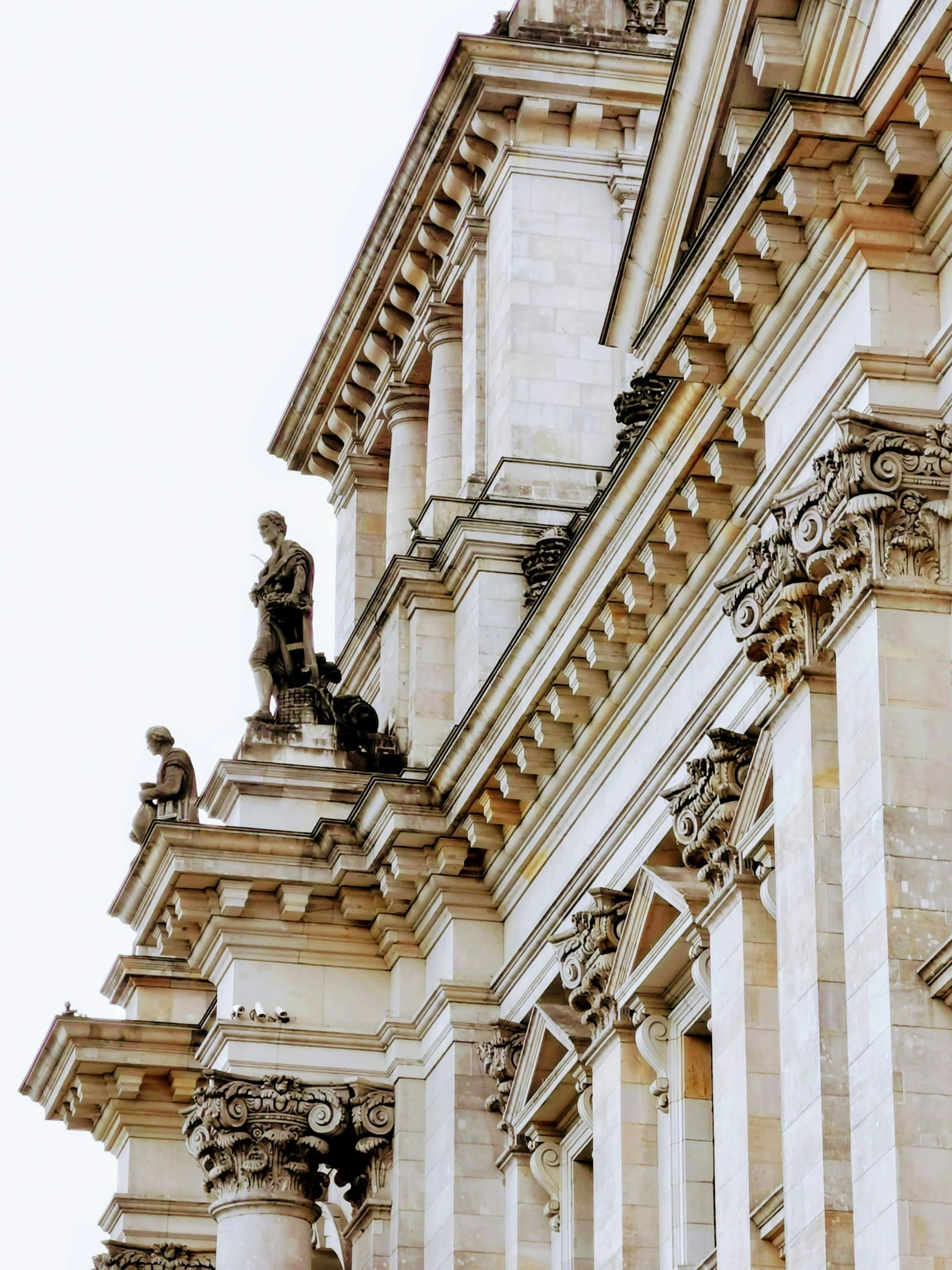 tall buildings with many statues on the front