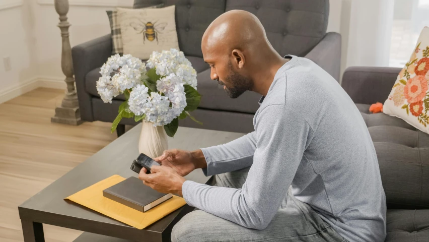 a man sitting at a table with an open book