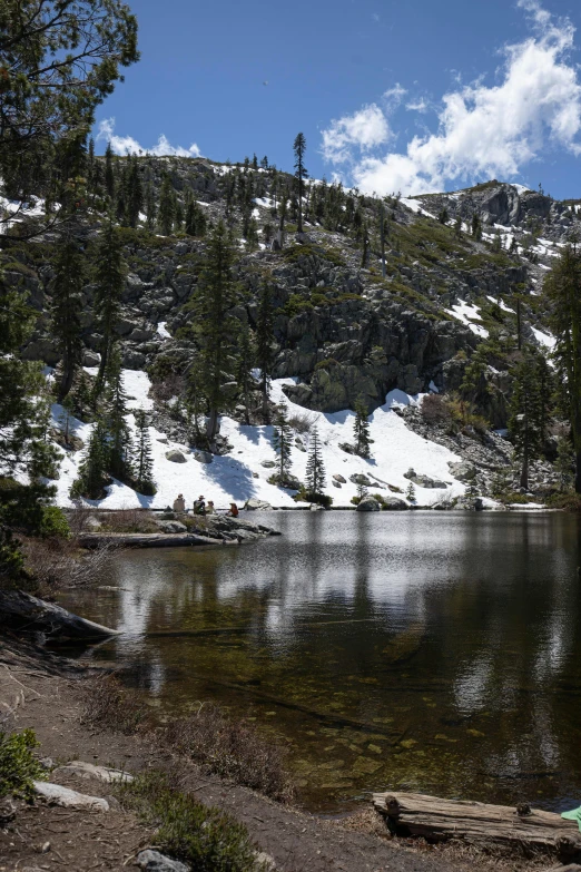 a mountain landscape with water and trees