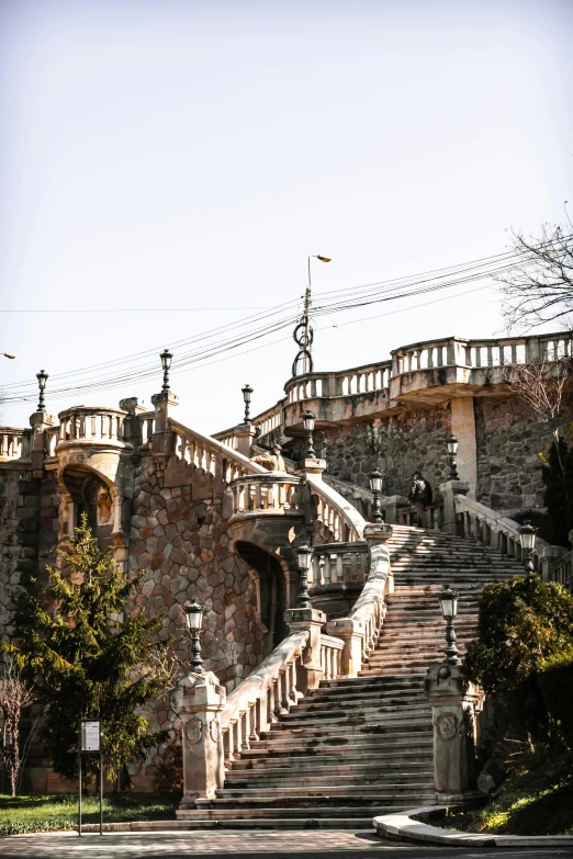 the stairs have wrought iron railings and are surrounded by trees