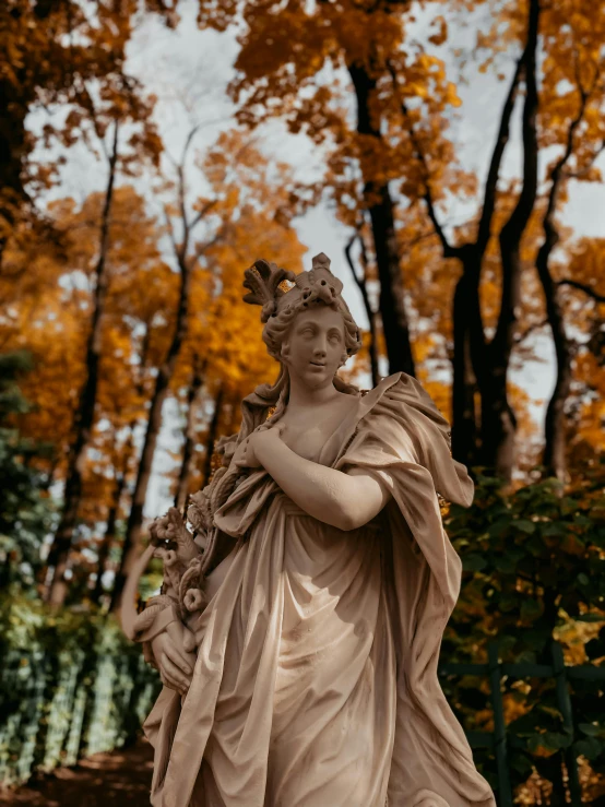 a statue of an angel holding a crown of flowers