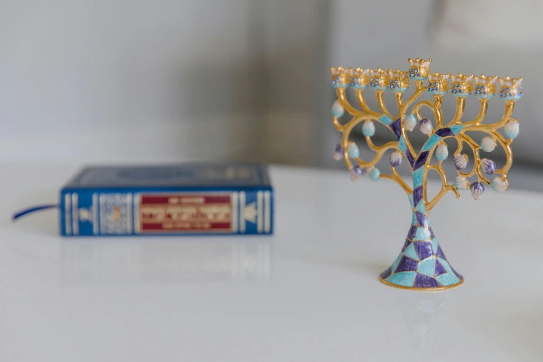 there is a small gold menorah on the table