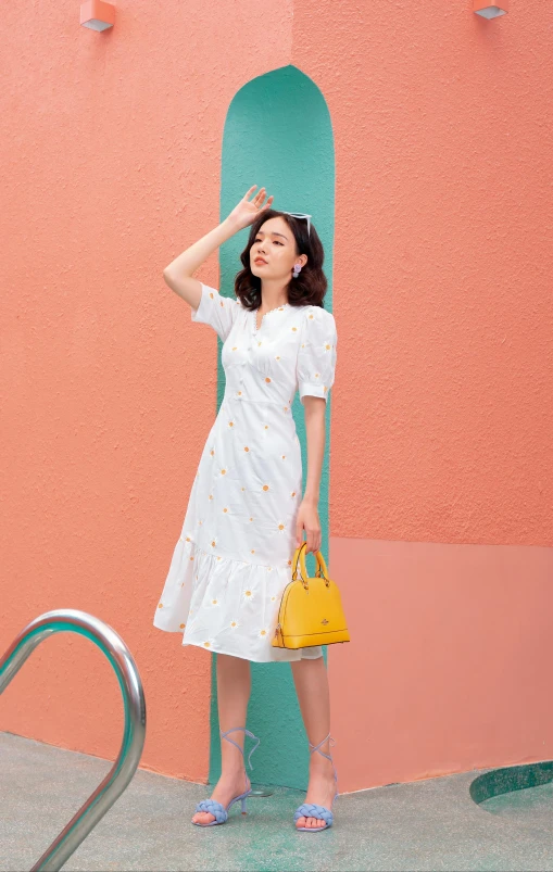 a girl standing in front of a colorful wall