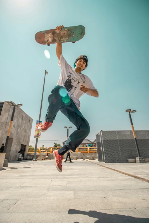 a boy on a skateboard jumps up into the air