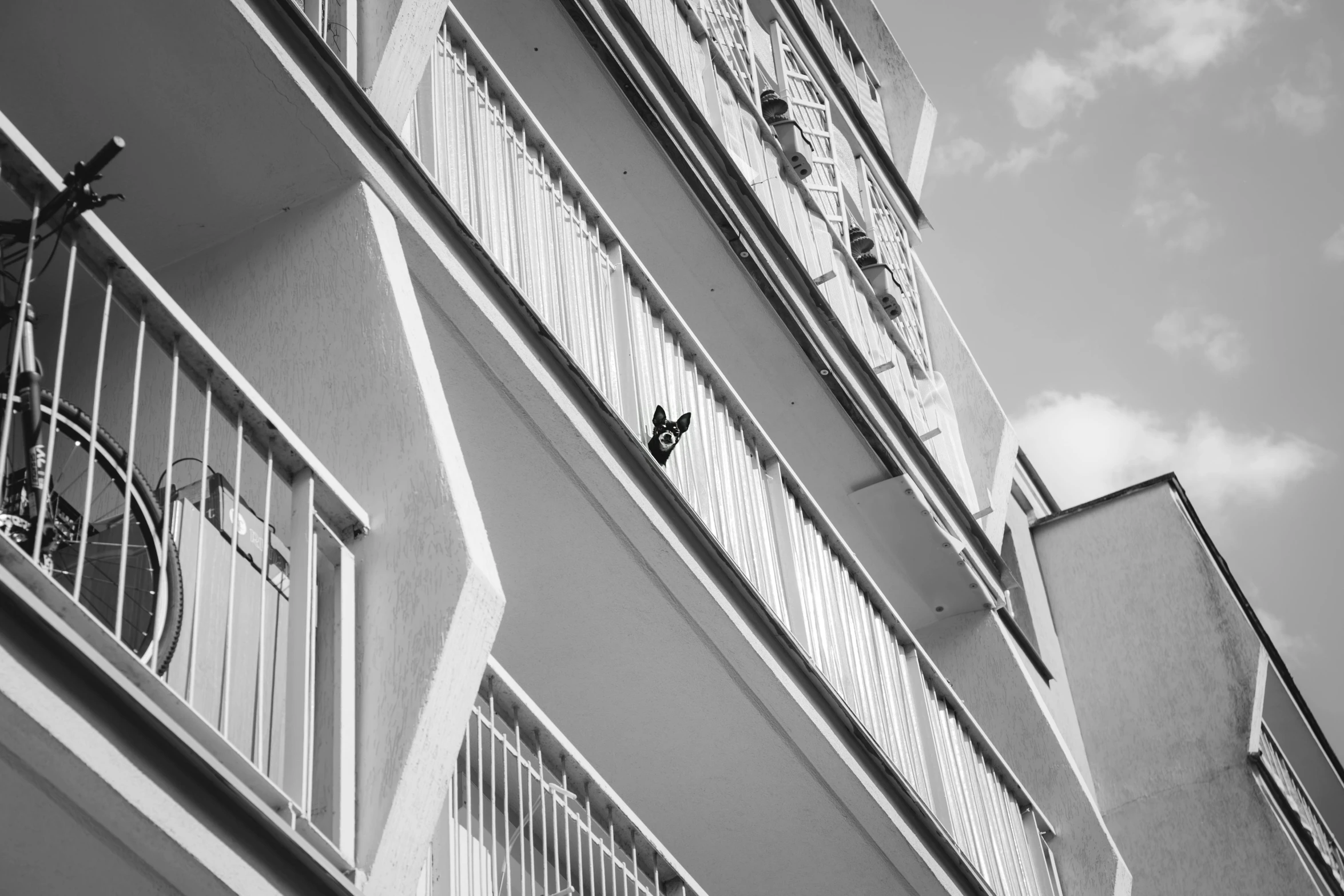 an apartment building with some iron balcony railings