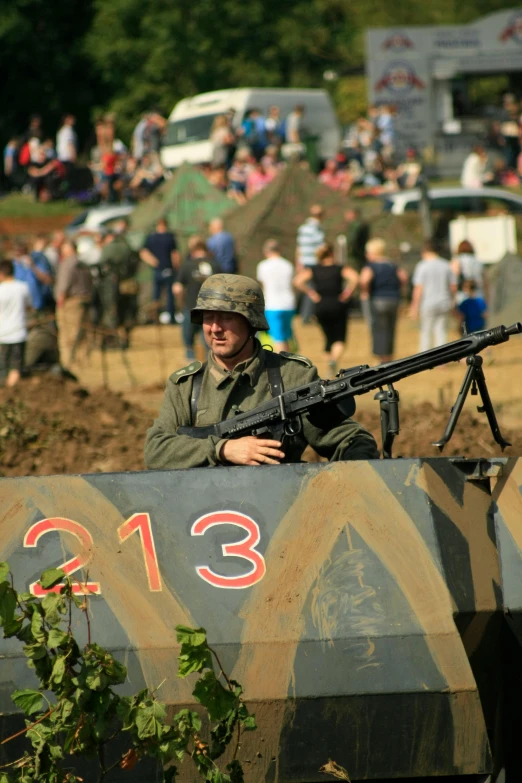 a soldier is sitting in the back of an army vehicle