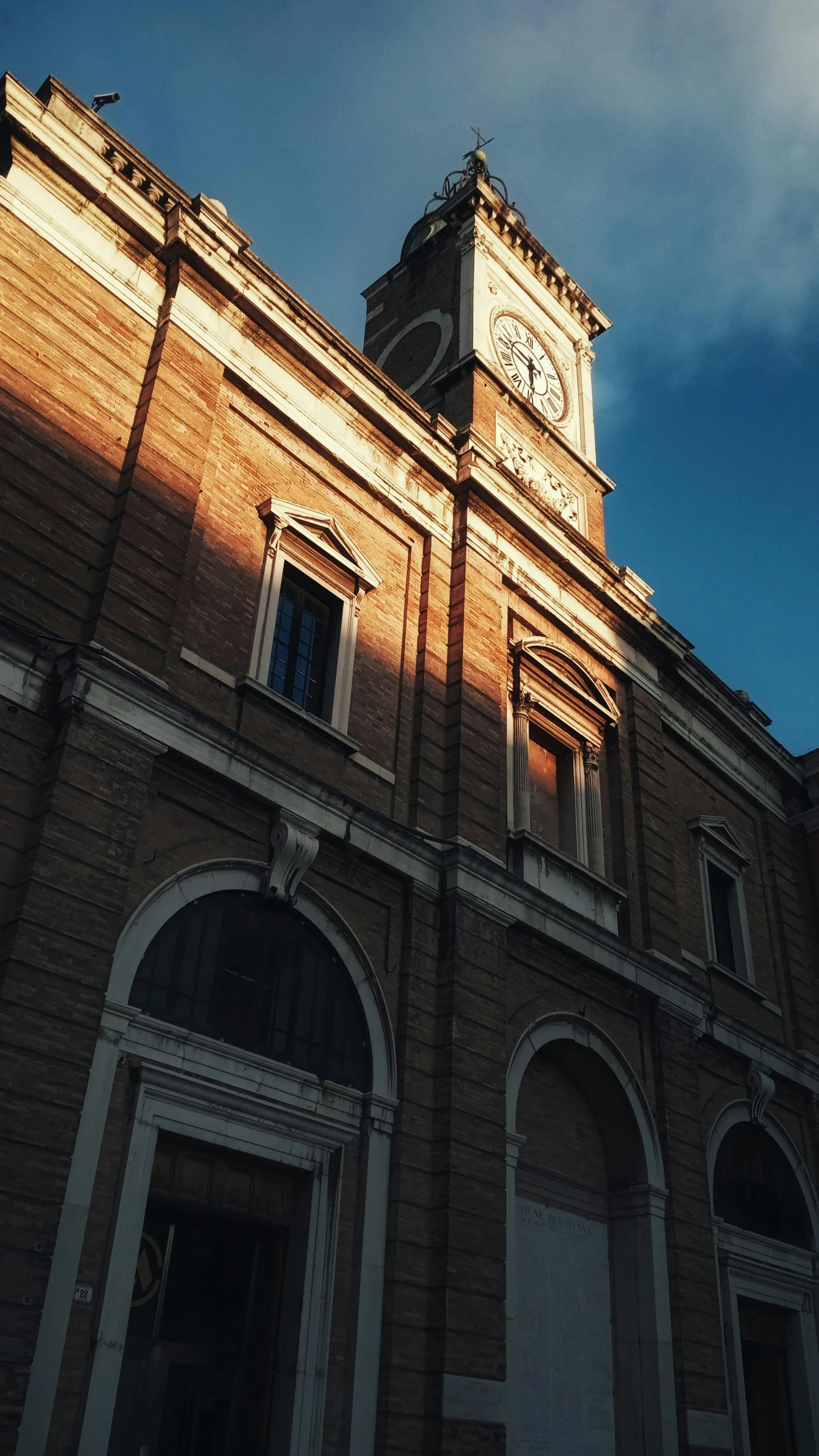 an old building with a clock tower and blue sky in the background