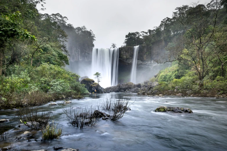 a view of a river with a waterfall in the background