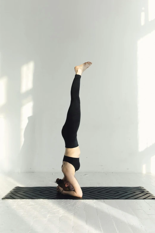 a woman is doing yoga on a mat