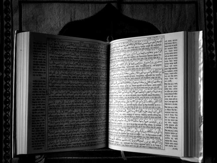 a large open book with arabic writing on it