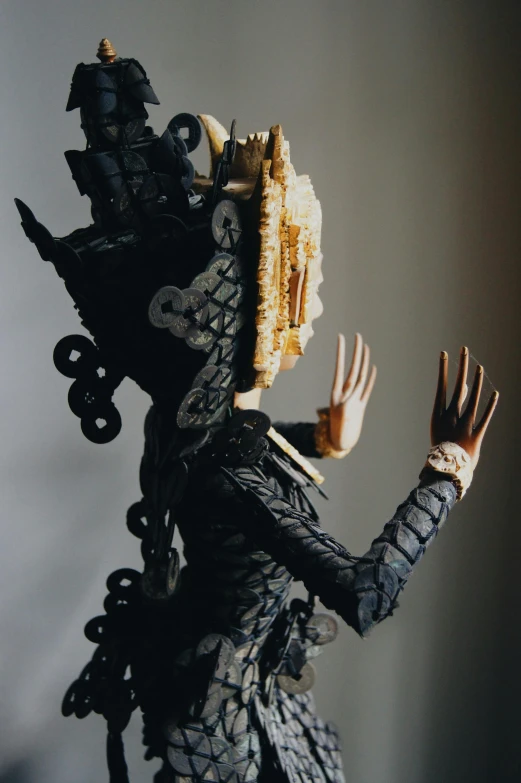 an artistic doll holding soing with both hands