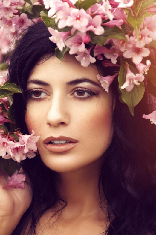 a woman in a floral headdress is holding flowers