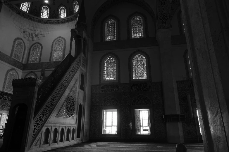 the interior of a building with windows and an ornate staircase