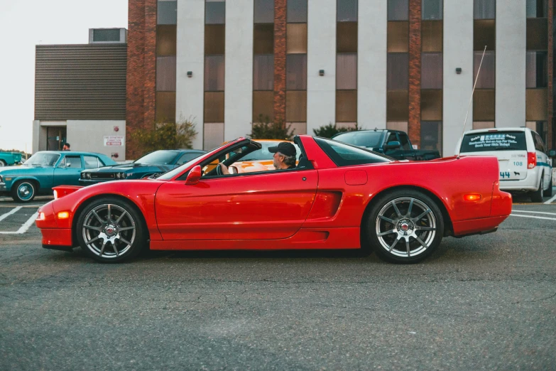 the sports cars are parked in a lot