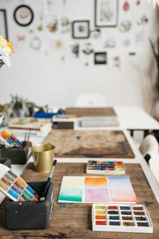 art and supplies sit on tables of different colors