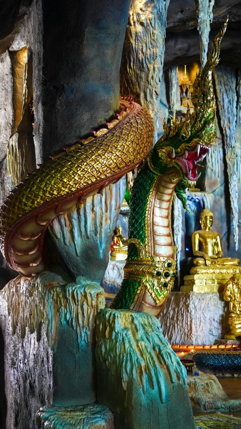 an elaborately colored dragon statue at the entrance to a buddhist temple