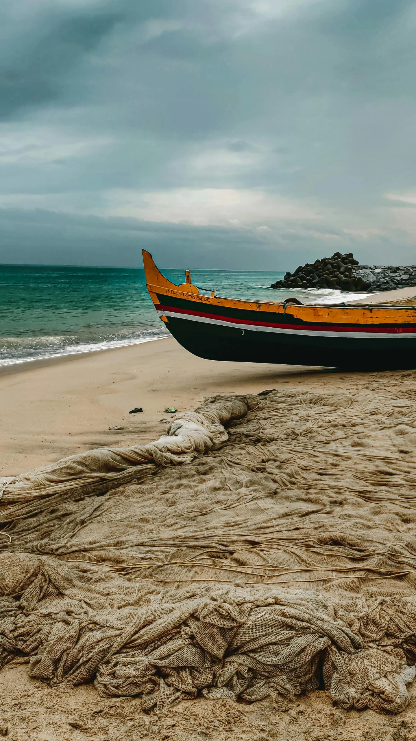 a boat is sitting on the beach and some sand