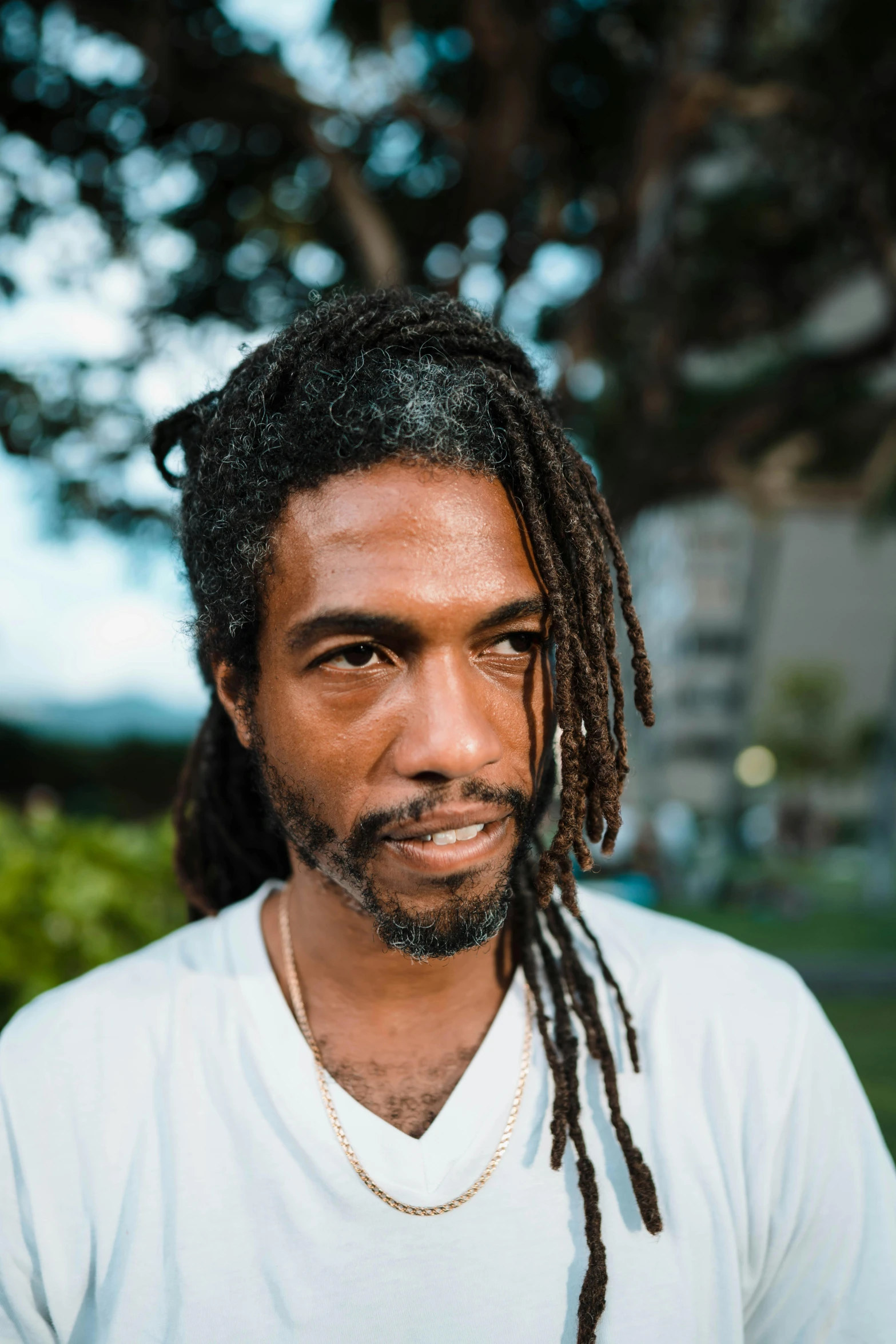 a man with dreads and a white t shirt