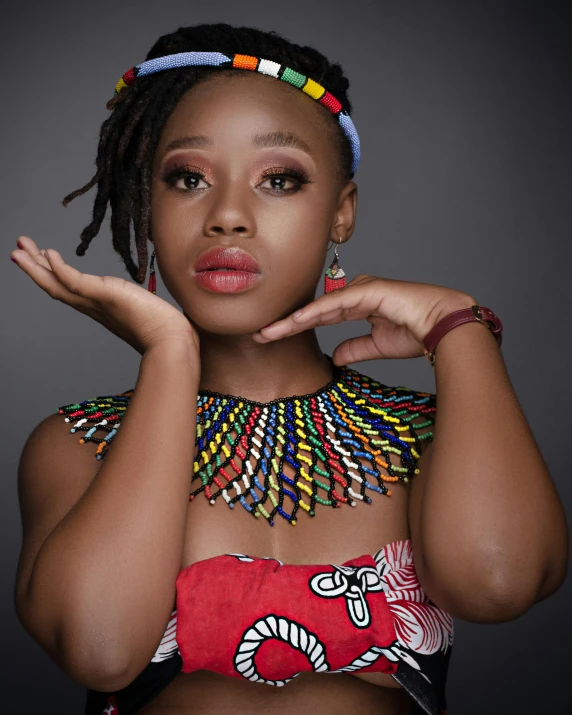 a woman with colorful necklaces on her neck posing for the camera