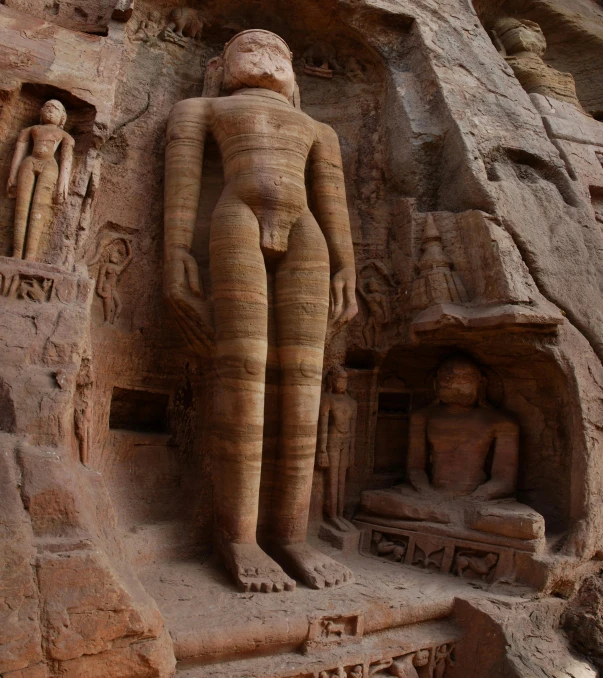 a carved statue sitting on a cement surface