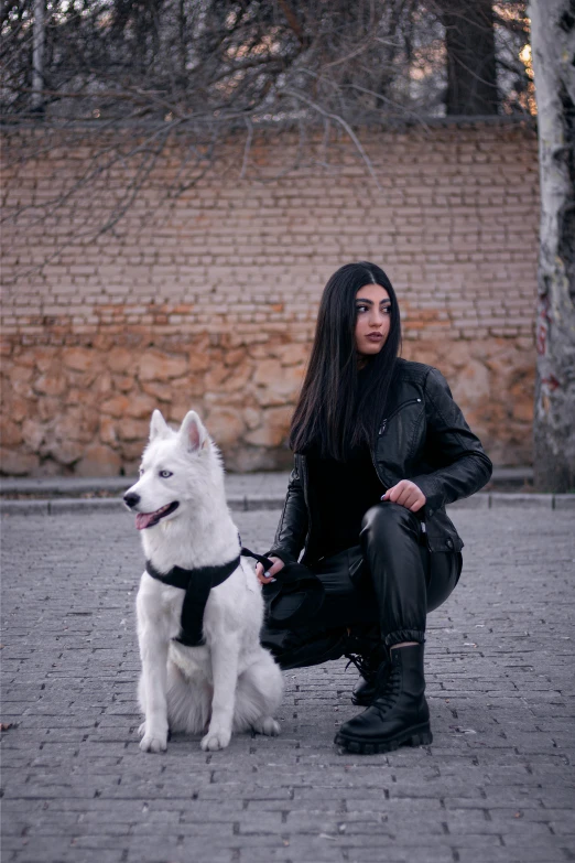 the woman with the dog is posing on the street