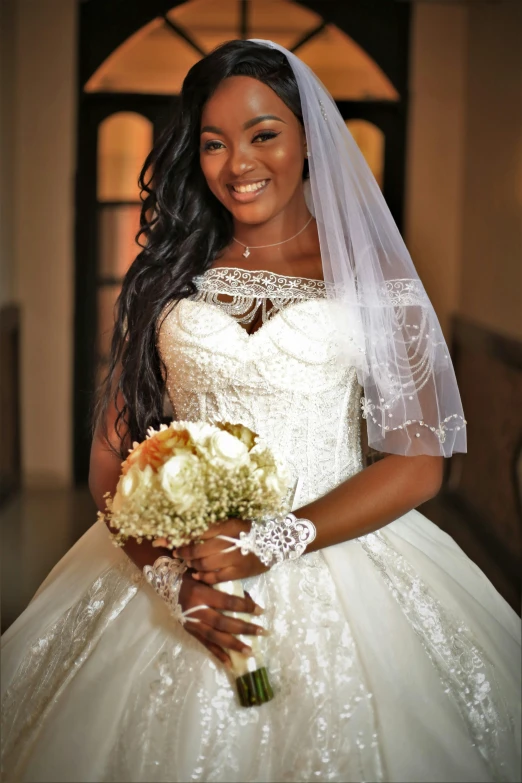 a woman in a wedding dress holding her bouquet