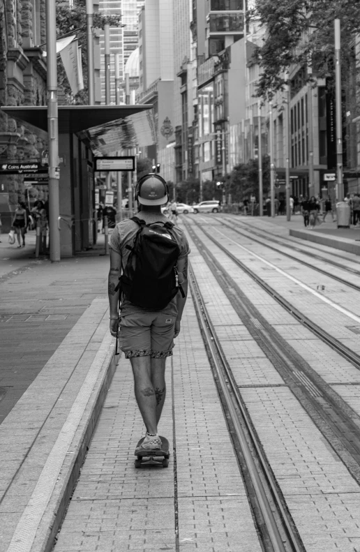 a person walking down a sidewalk with a backpack on