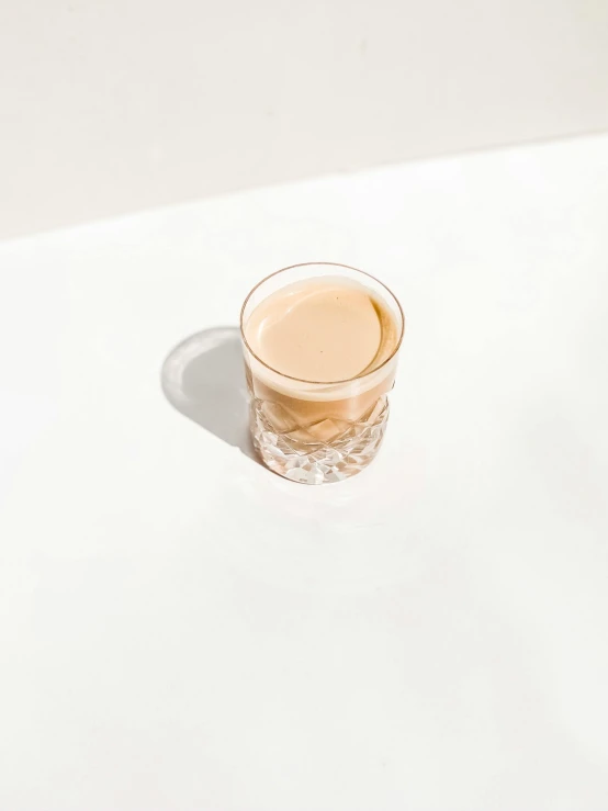 a cup sitting on top of a white table