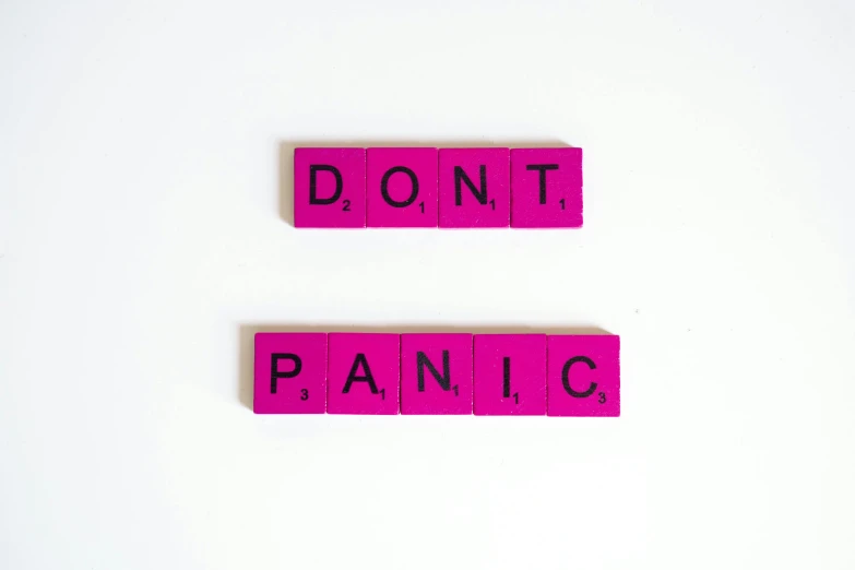 two pink type blocks with words that spell out don't panic