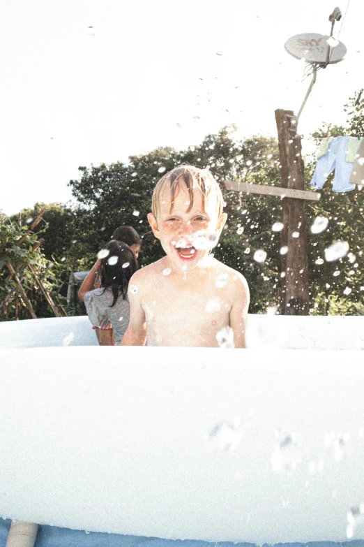 a  in the bathtub has soing white on his face