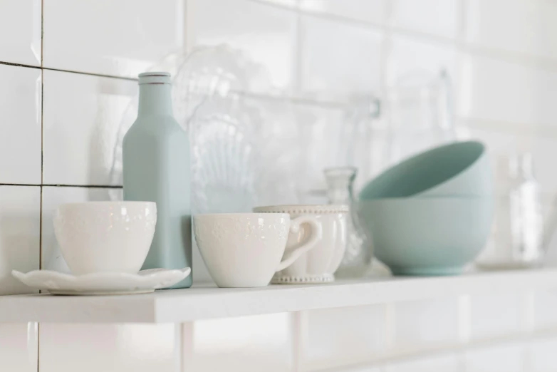 close up of dishes on shelf with glassware