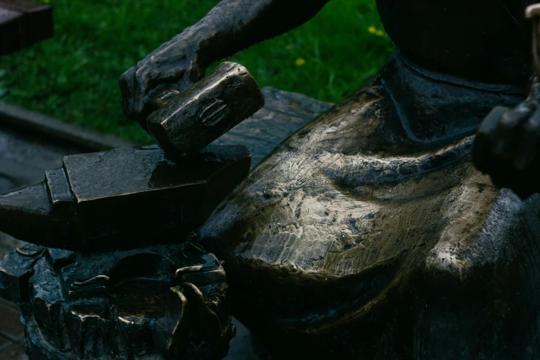 a bronze statue being made using an old metal tool