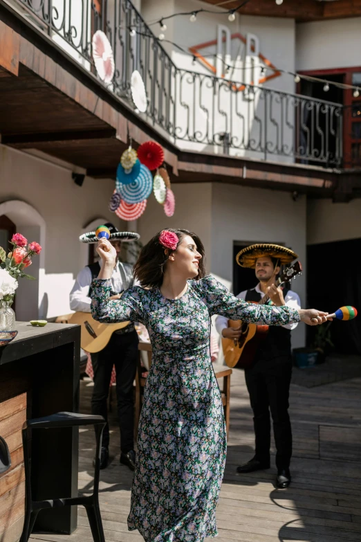 the woman is juggling some colorful streamers above her head