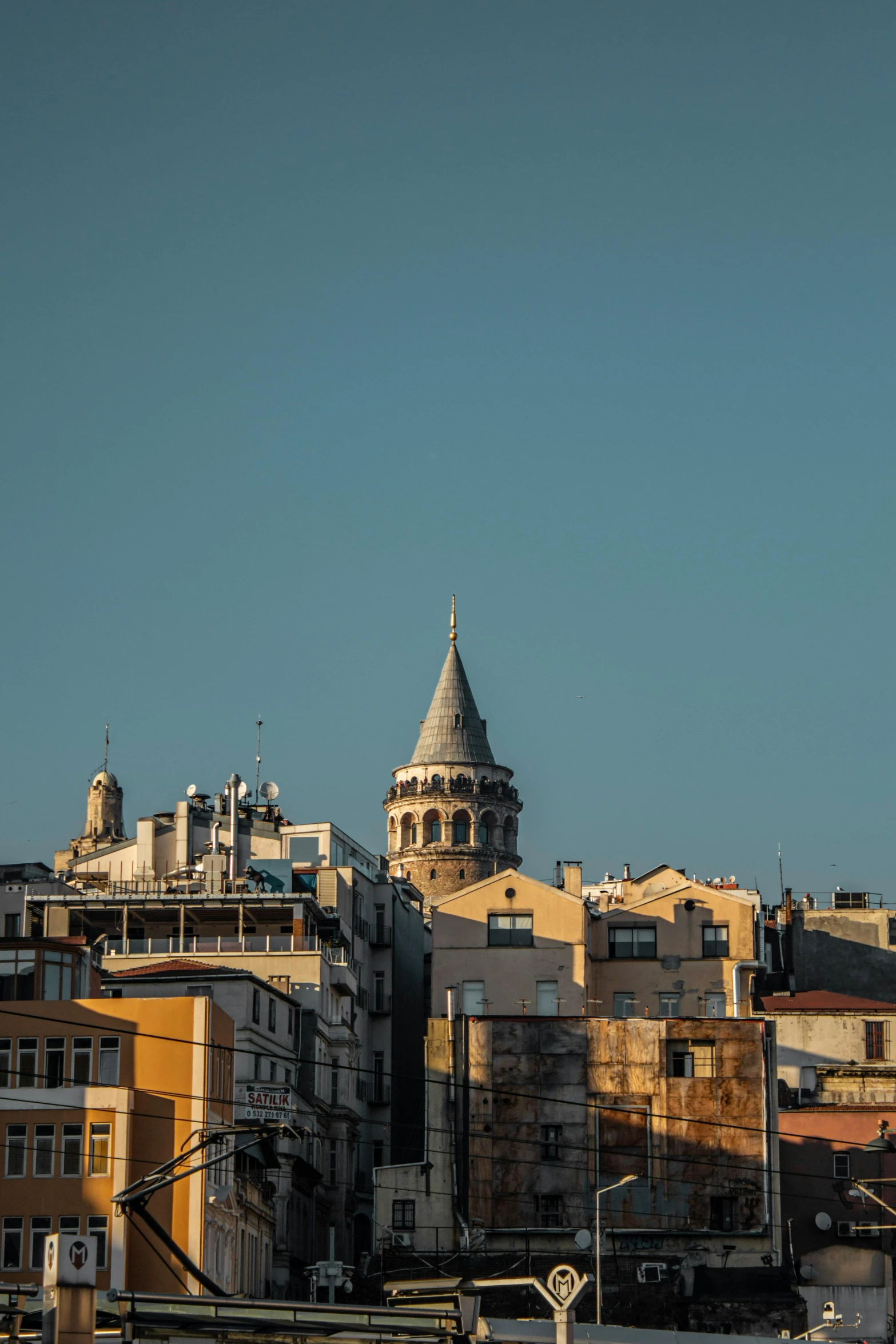 a city that has buildings, a traffic light and a clock tower