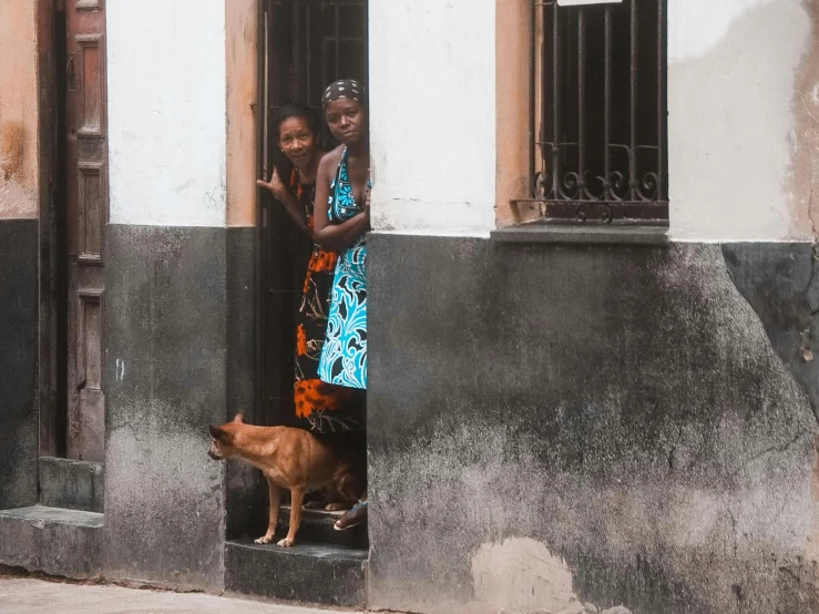 two s in their window with a dog on the ground