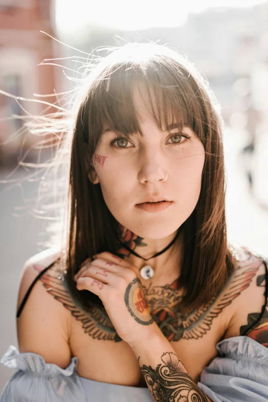 a beautiful young lady wearing a blue dress and tattoos