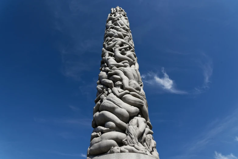 a tall stone sculpture sitting under a blue sky