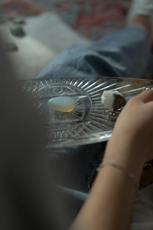 a person sitting down and holding onto some pieces of food