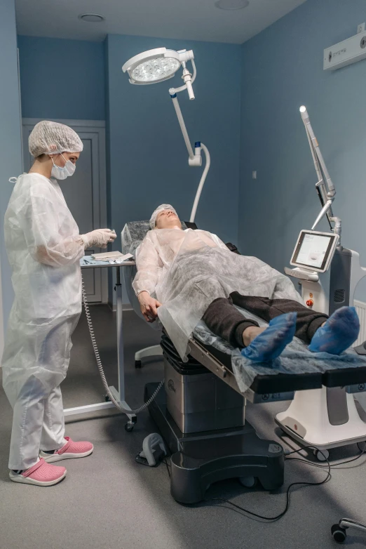 a person lying in a hospital bed while being examined