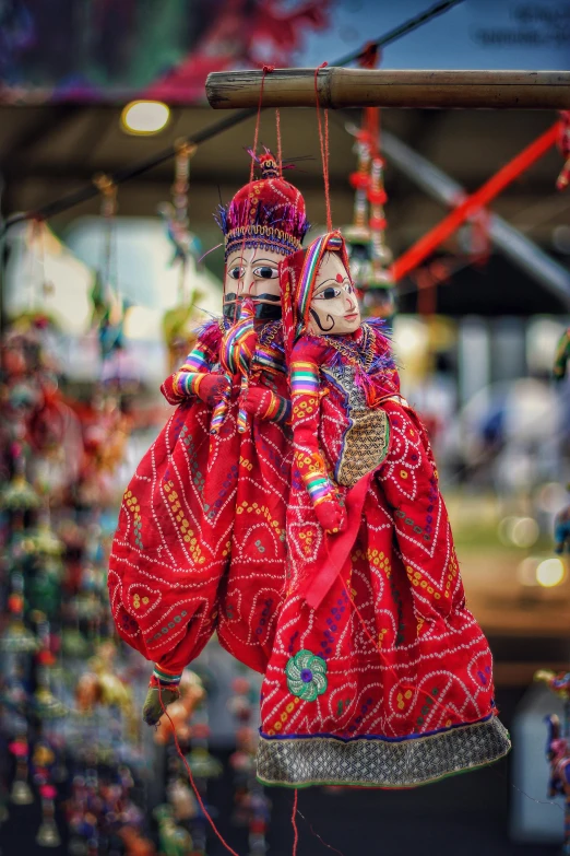 decorative red cloths hang from strings at the market