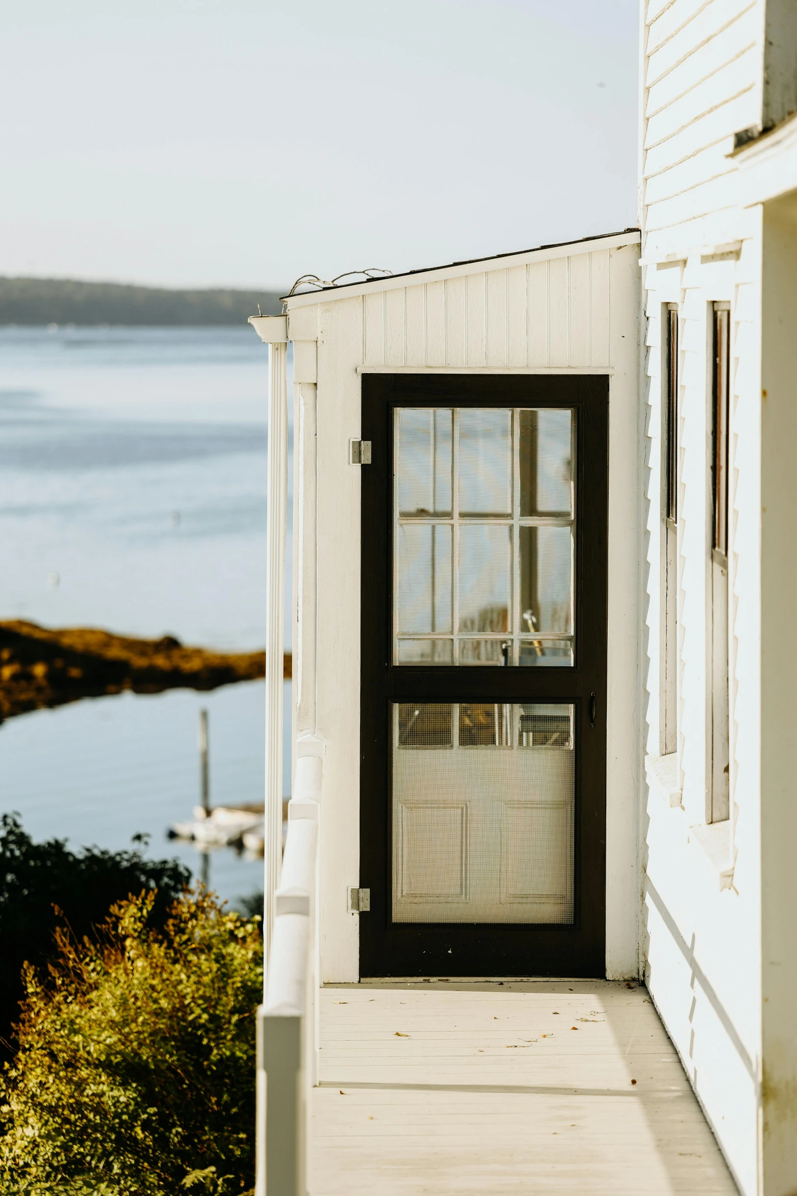 this house has a screen door on the front porch