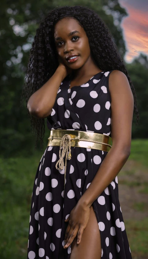 a woman in a polka dot dress posing for a po