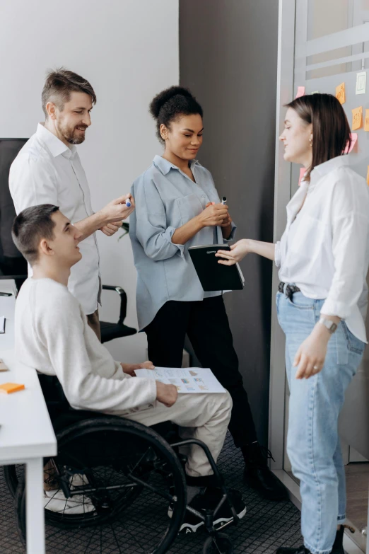 the group of people are standing around a door