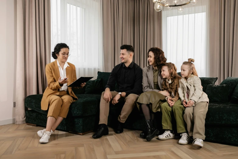 a group of young people sitting next to each other on a couch