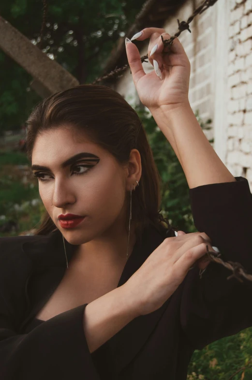 a woman is putting on makeup for her fashion shoot